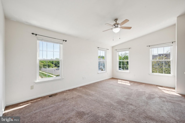 unfurnished room with baseboards, visible vents, lofted ceiling, ceiling fan, and carpet flooring