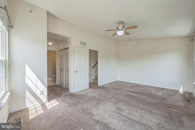 spare room with baseboards, ceiling fan, visible vents, and carpet flooring