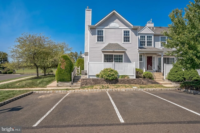 multi unit property featuring uncovered parking and a chimney