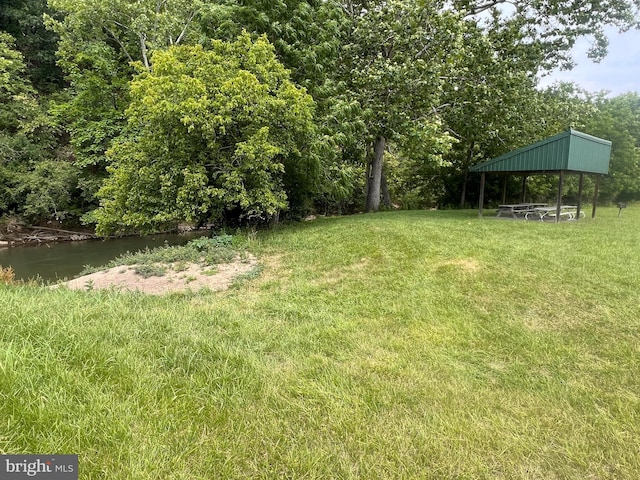 view of yard with a water view and a gazebo