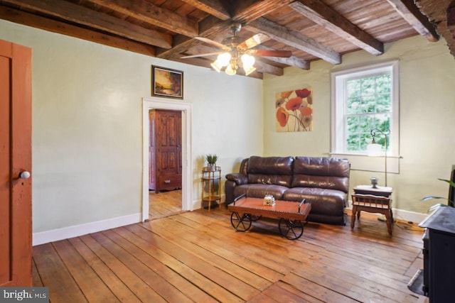 living room with wood-type flooring, beam ceiling, and ceiling fan