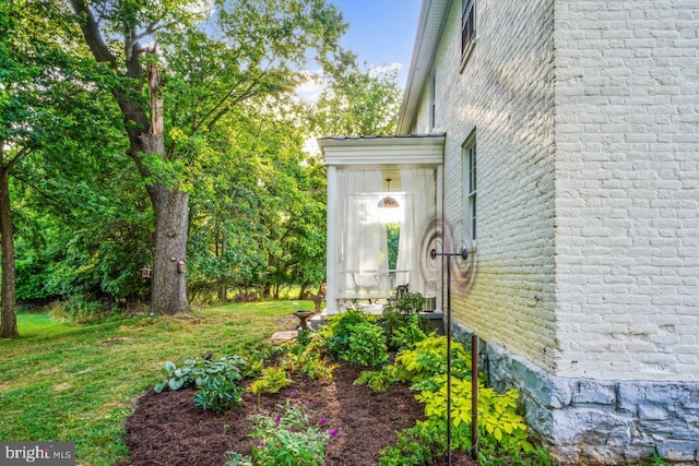 view of side of property with a lawn