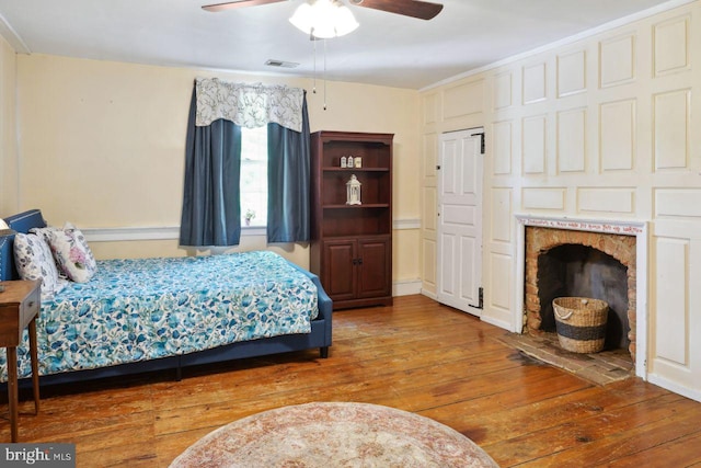 bedroom with hardwood / wood-style floors and ceiling fan