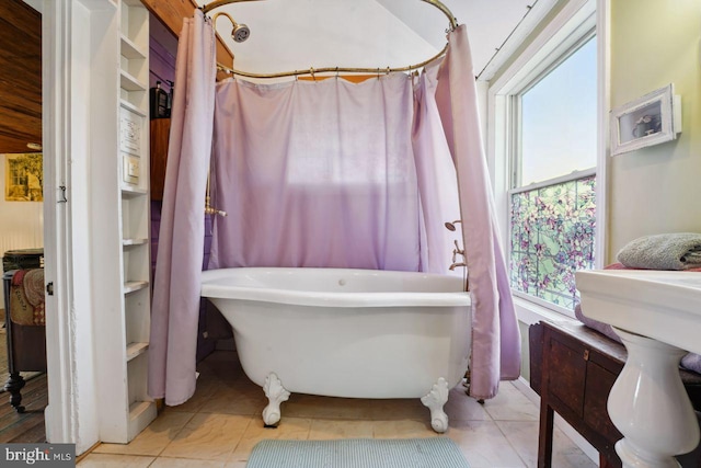 bathroom with shower / tub combo and tile patterned flooring