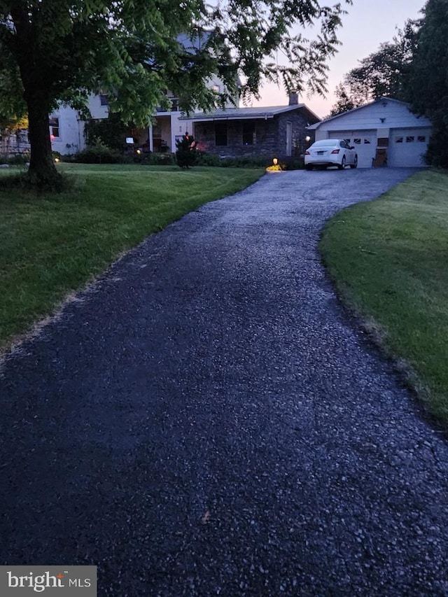 view of front of property with a yard and a garage