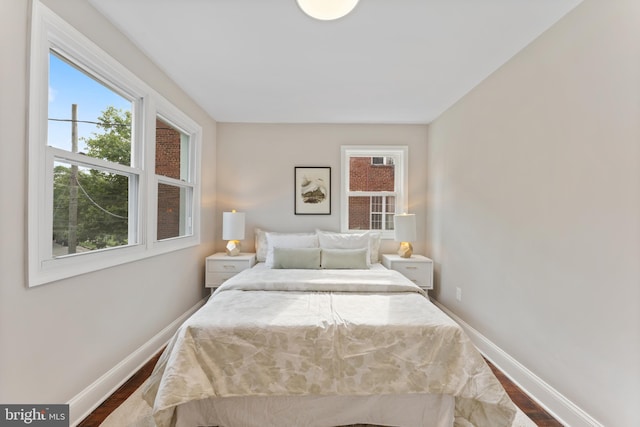 bedroom with dark hardwood / wood-style flooring