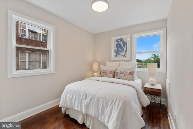 bedroom with dark hardwood / wood-style flooring