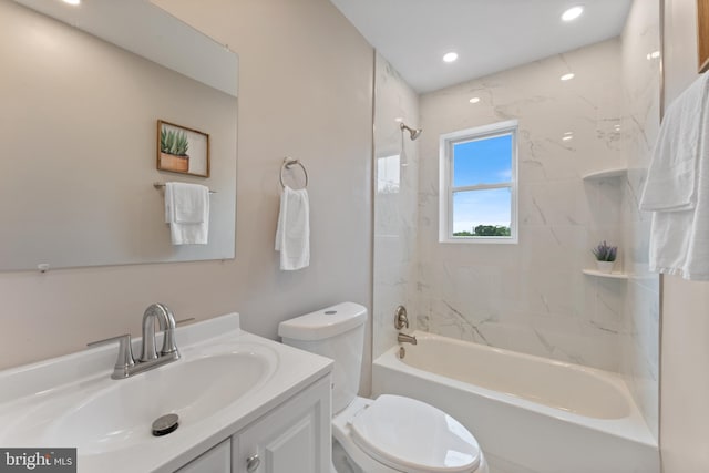 full bathroom featuring vanity, toilet, and tiled shower / bath