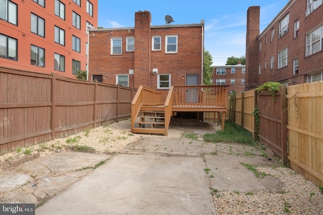 back of property featuring a deck