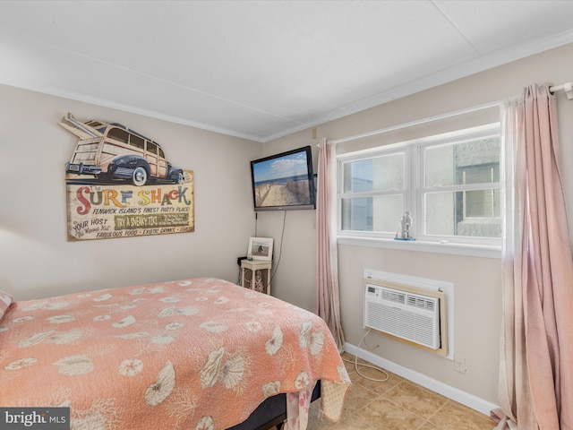 tiled bedroom with a wall unit AC and baseboards