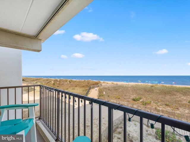 balcony featuring a water view and a view of the beach