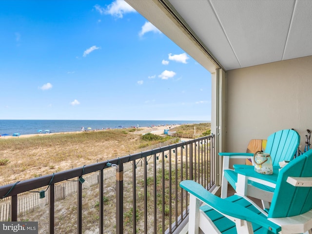 balcony with a view of the beach and a water view