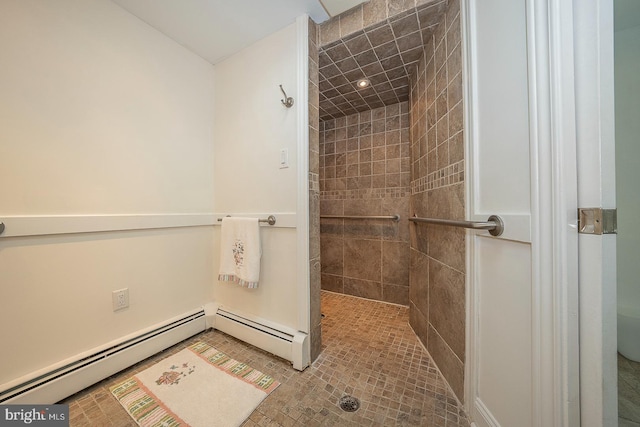 bathroom with baseboard heating and a tile shower