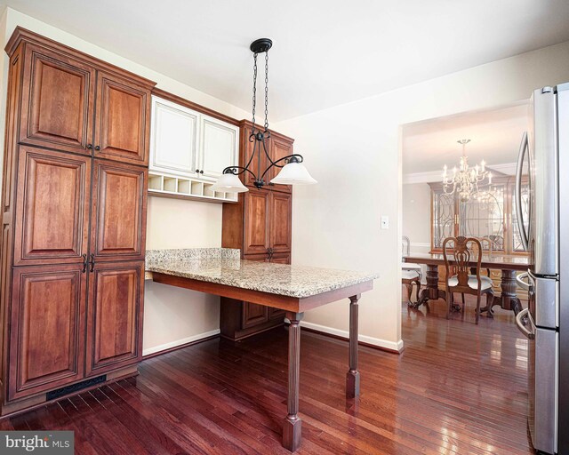 dining area featuring dark hardwood / wood-style floors and a notable chandelier