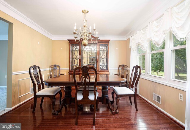 dining area with ornamental molding, dark hardwood / wood-style floors, and a notable chandelier