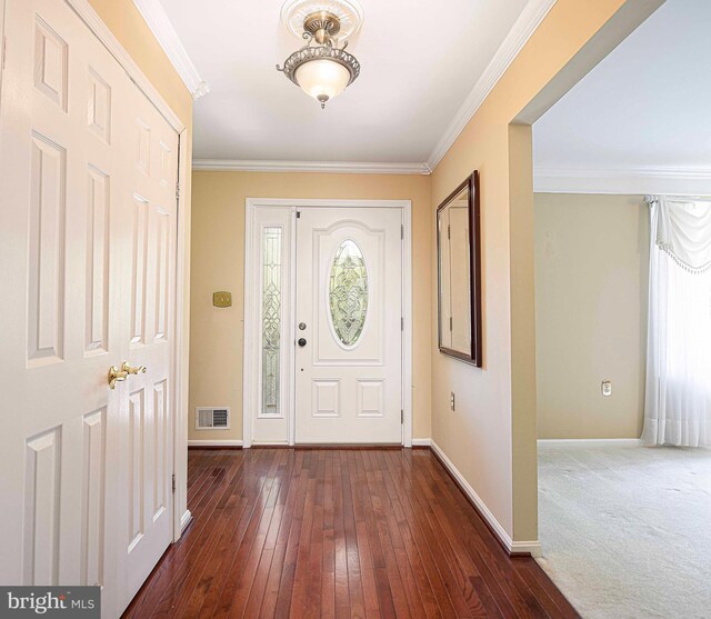 foyer entrance featuring ornamental molding and dark hardwood / wood-style floors