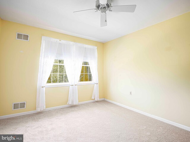 spare room featuring ceiling fan and carpet flooring