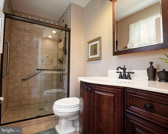 bathroom featuring tile patterned floors, walk in shower, toilet, and vanity