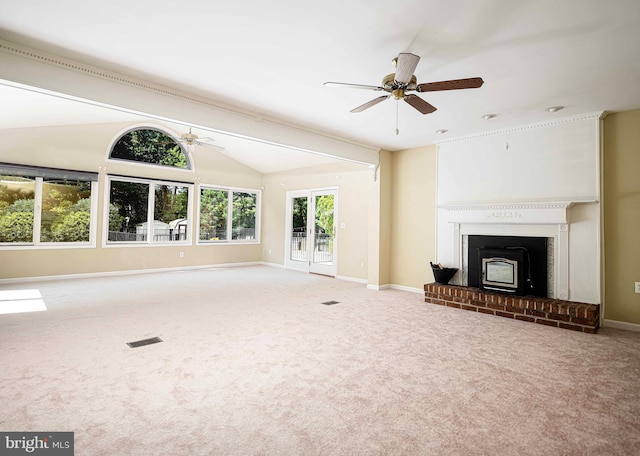 unfurnished living room featuring carpet, ceiling fan, a brick fireplace, and vaulted ceiling