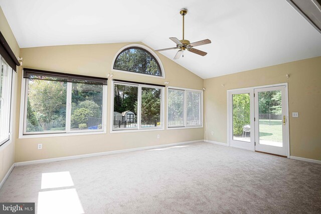 carpeted spare room with high vaulted ceiling and ceiling fan