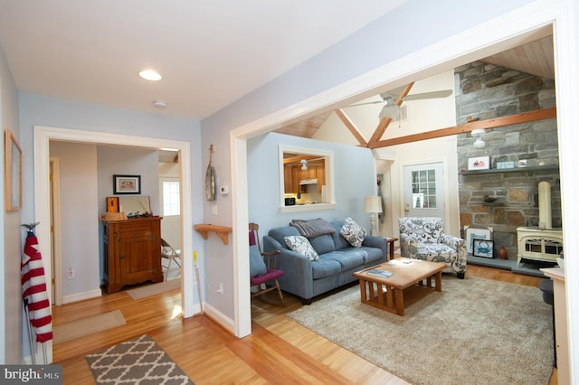 817 Seabreeze Rd, Cambridge, MD 21613 - living area featuring wood finished floors, baseboards, vaulted ceiling, and a wood stove