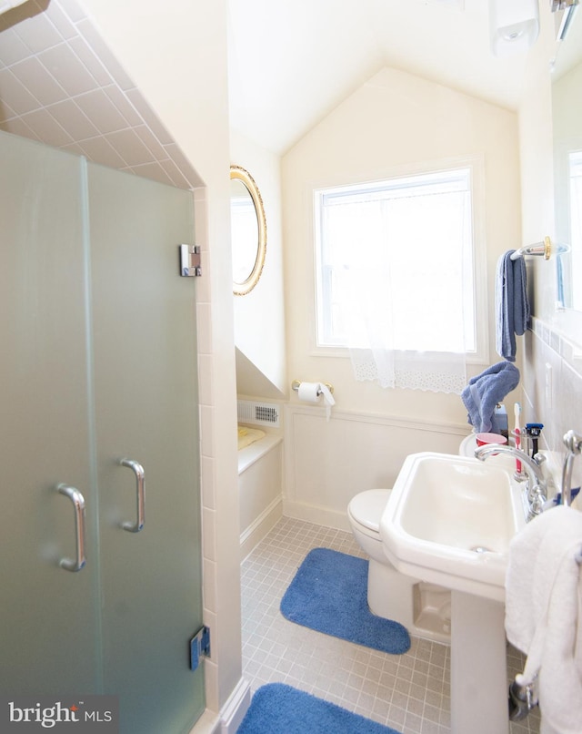 817 Seabreeze Rd, Cambridge, MD 21613 - bathroom featuring tile patterned flooring, vaulted ceiling, toilet, baseboards, and a shower stall