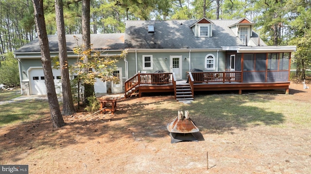 817 Seabreeze Rd, Cambridge, MD 21613 - back of house featuring a sunroom, a wooden deck, an outdoor fire pit, a garage, and a yard