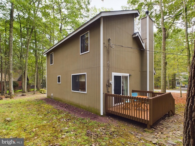 view of side of property featuring a wooden deck