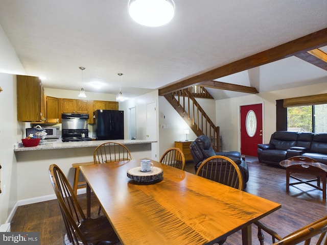 dining space with beamed ceiling and dark hardwood / wood-style floors