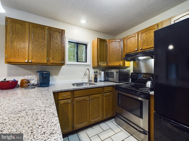 kitchen featuring a textured ceiling, appliances with stainless steel finishes, and sink