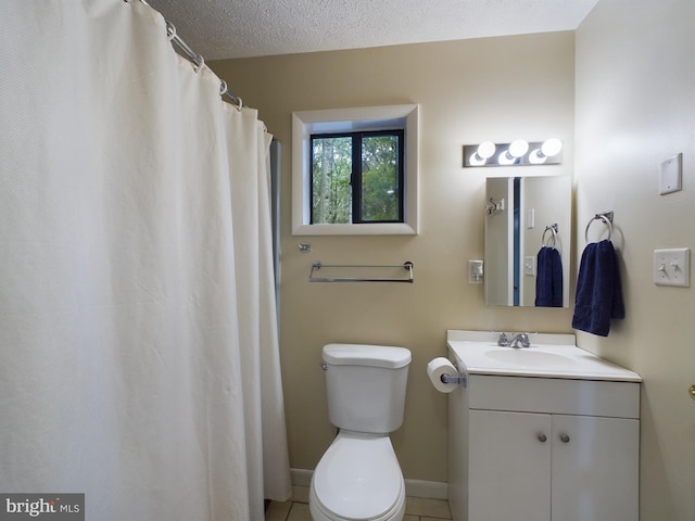 bathroom featuring vanity, tile patterned flooring, toilet, and a textured ceiling