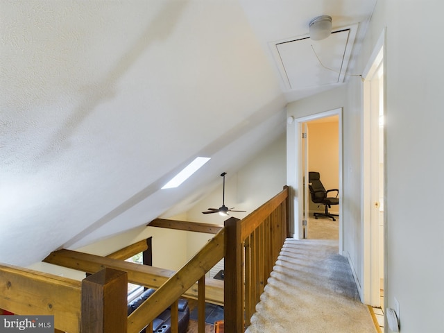 hall with light carpet and lofted ceiling