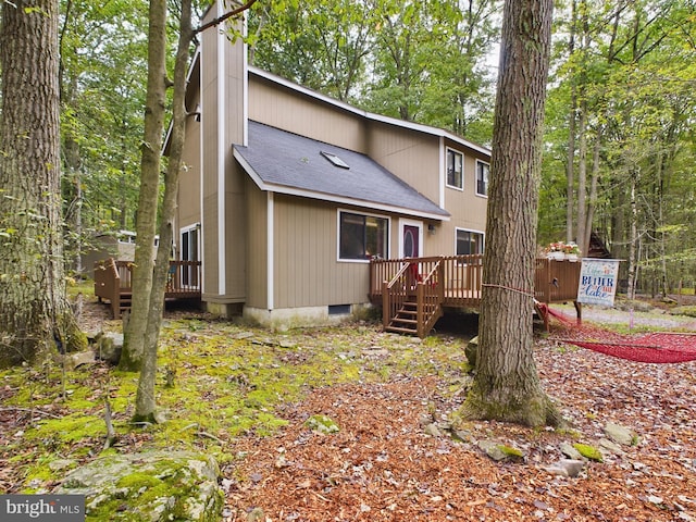 rear view of house with a wooden deck