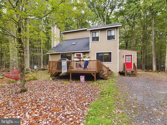 back of house featuring a deck