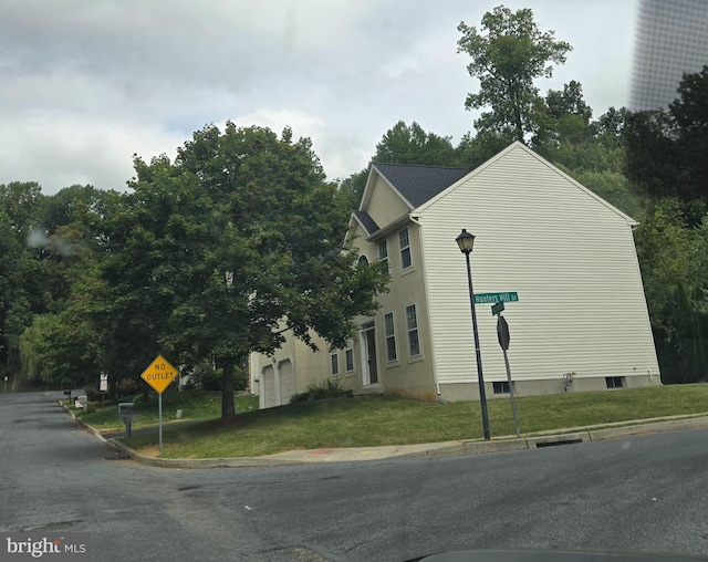 view of home's exterior with a yard