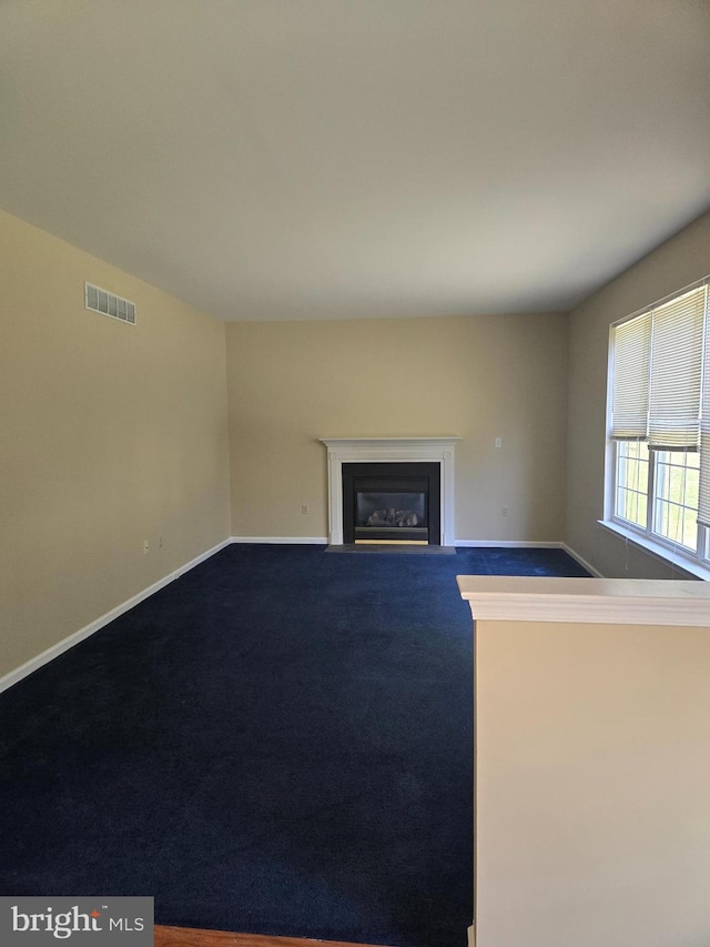 unfurnished living room with carpet flooring