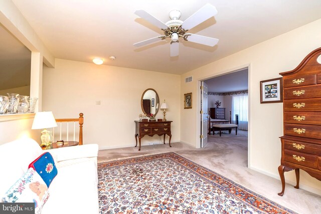 living room with ceiling fan and carpet flooring