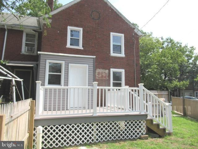 back of house with a wooden deck