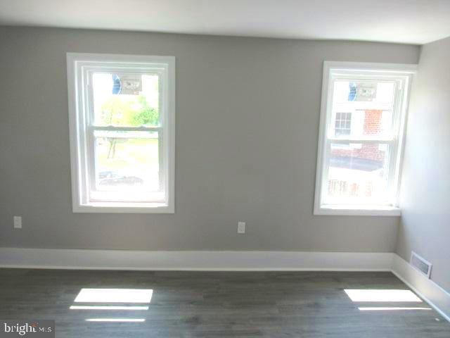 spare room with dark hardwood / wood-style flooring