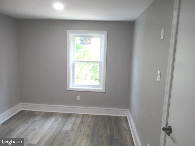 spare room with hardwood / wood-style flooring