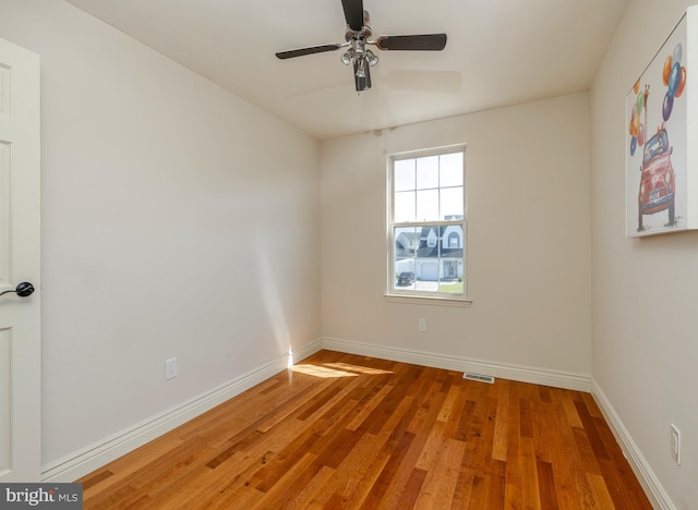 unfurnished room with ceiling fan and hardwood / wood-style floors