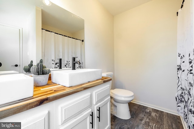 bathroom featuring vanity, toilet, and wood-type flooring