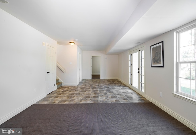 unfurnished room featuring french doors