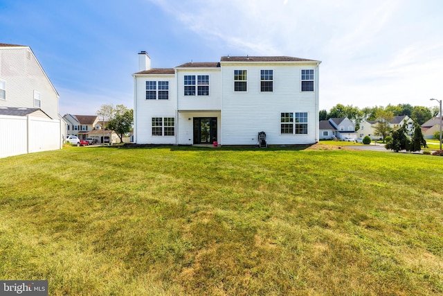 rear view of house with a lawn