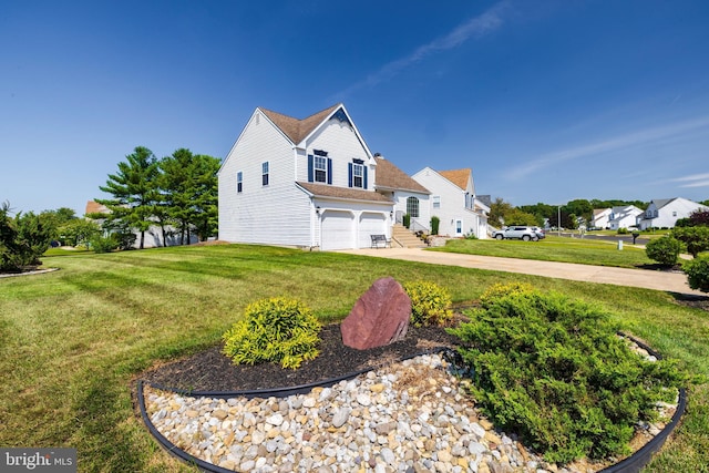 view of front of home with a front yard and a garage