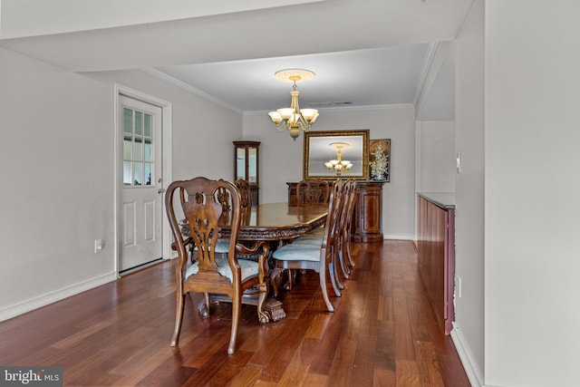 dining room with crown molding, dark hardwood / wood-style floors, and a notable chandelier