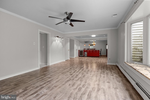 unfurnished living room with crown molding, ceiling fan, a baseboard heating unit, and hardwood / wood-style flooring