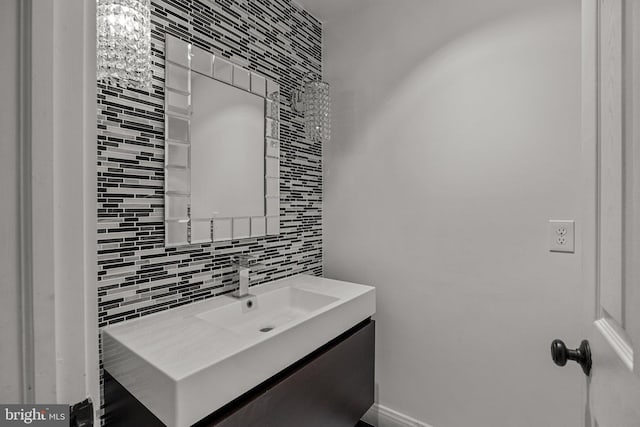 bathroom with vanity and tasteful backsplash