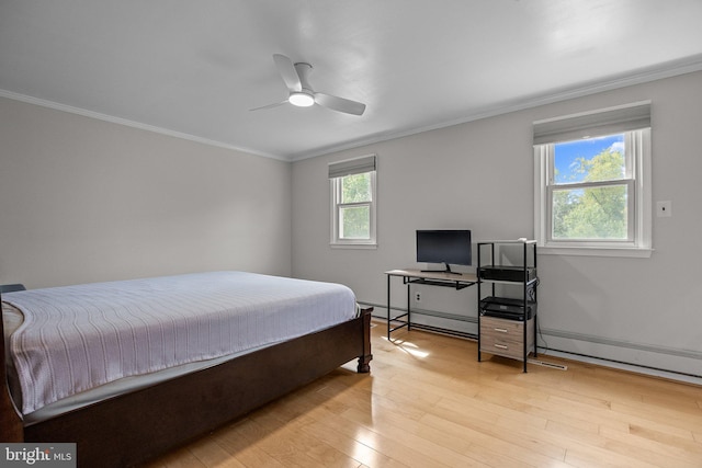 bedroom with crown molding, light hardwood / wood-style floors, a baseboard heating unit, and ceiling fan