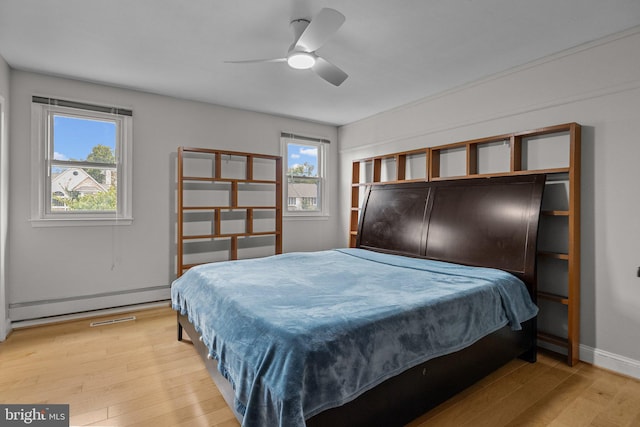 bedroom featuring multiple windows, light wood-type flooring, and ceiling fan